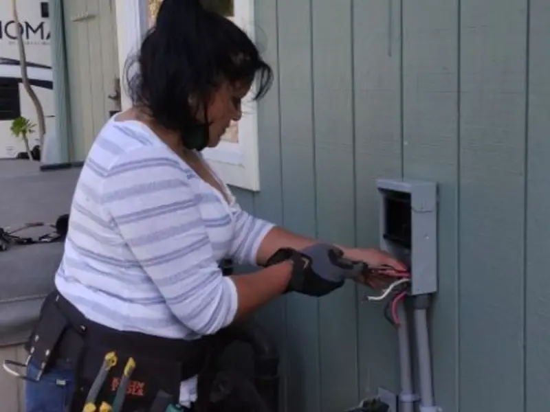 Licensed electrician wiring an exterior subpanel in Pinewood
